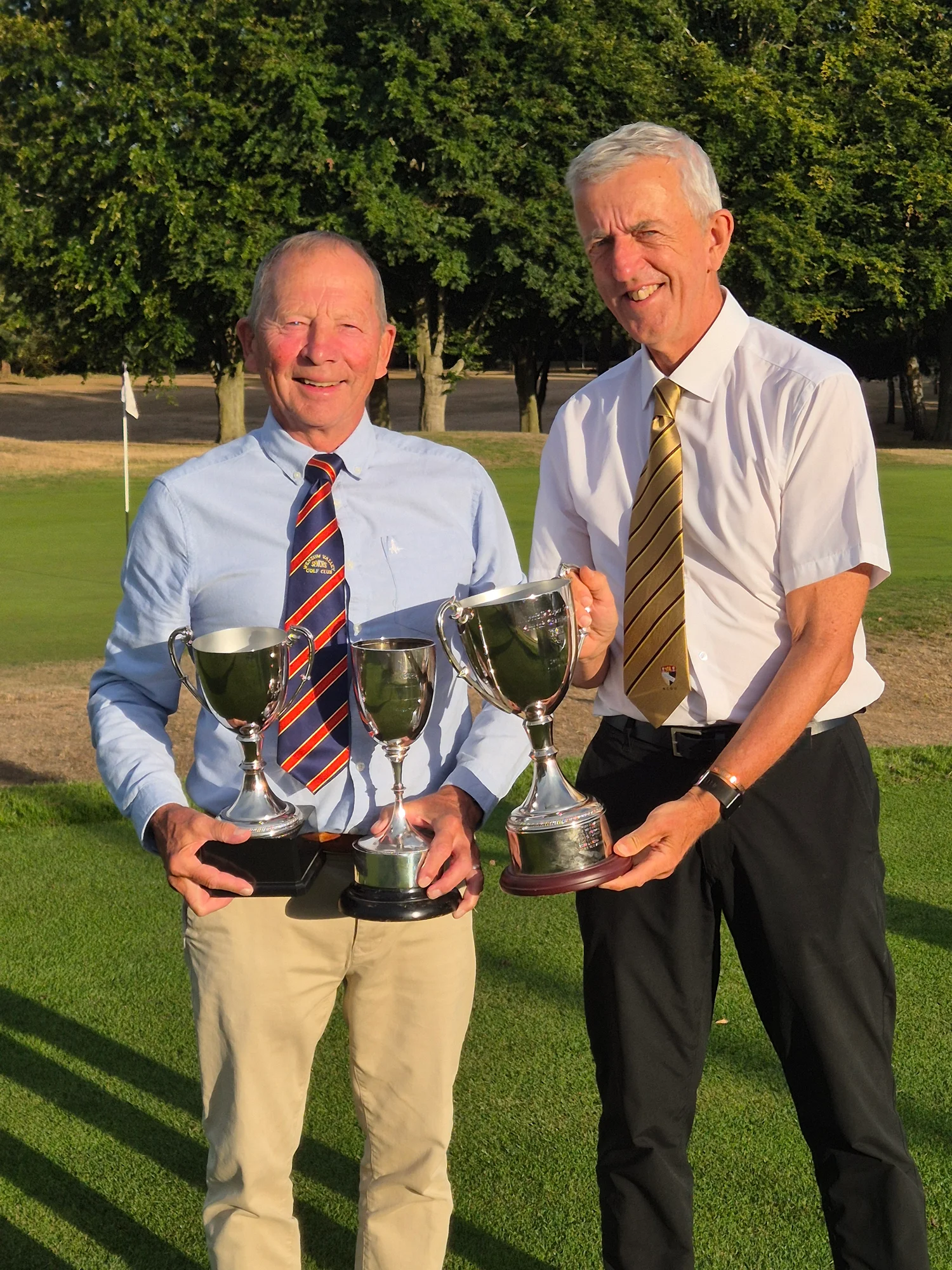 Wensum Valley's Bernie Vaughan receives the County Seniors Handicap, Super Seniors Scratch and Super Seniors Handicap trophies from Chris Lamb